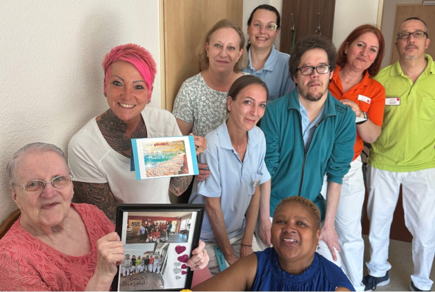 Krefeld: Bewohnerin und Mitarbeitende mit Abschiedsgeschenken.